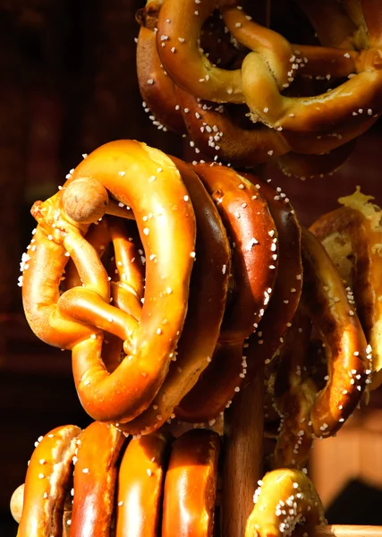Pretzels hanging on stand at Christmas food market — Stock Photo, Image