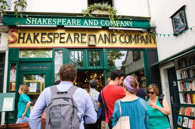 Tourists near the Shakespeare and Company bookstore and library clipart
