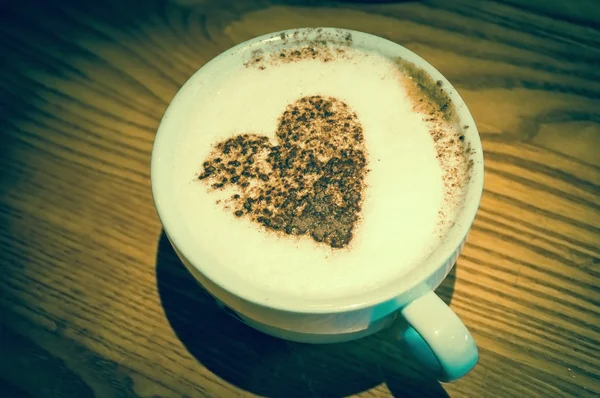 Cup of coffee with heart shape on milk foam — Stock Photo, Image