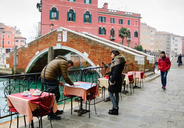 Venice, İtalya - 13 Şubat 2015: bakarak turist Haritası Karnaval sırasında (maskeler tutan kadın). Karnaval Venedik shrove Salı günü sona eriyor yıllık olaydır — Stok fotoğraf