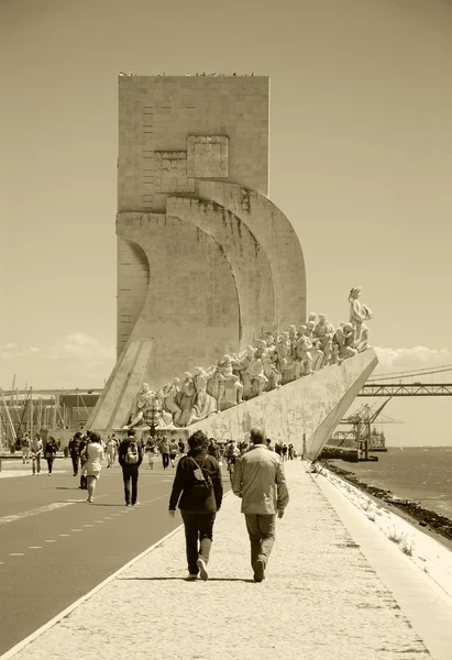 LISBON, PORTUGAL - APRIL 22, 2015: Tourists visit the Monument to the Discoveries (Padrao dos Descobrimentos) over Tagus River in Belem quarter. Aged photo. Black and white.
