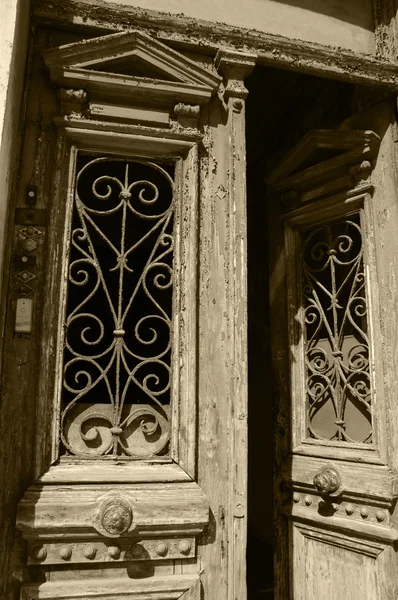 Opened door with bell buttons. Entrance to the old residential building in the centre of Lisbon (Portugal). A game of light and shadow.  Aged photo. Sepia. — Stock Photo, Image