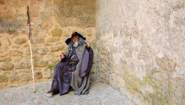 OBIDOS, PORTUGAL - APRIL 30, 2015: Unidentified senior actor performs as Gandalf from The Lord of the Rings entertaining the tourists at the gate of medieval town of Obidos.