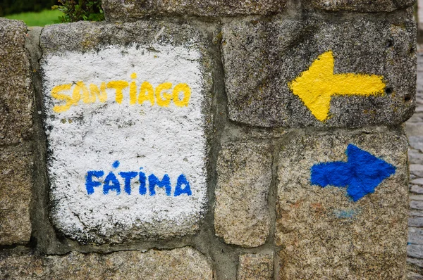 A sign near the cathedral of Porto pointing two important christian pilgrim destinations FATIMA (in Portugal) and SANTIAGO (Santiago de Compostela in Spain) — Stock Photo, Image