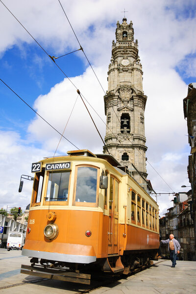 PORTO, PORTUGAL - APRIL 26, 2015: Unidentified senior man getting on the old tram near the Clerigos Tower, one of the famous landmarks and symbols of the city. 