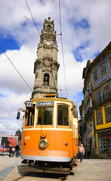 PORTO, PORTUGAL - APRIL 26, 2015: Unidentified senior man getting on the old tram near the Clerigos Tower, one of the famous landmarks and symbols of the city. 