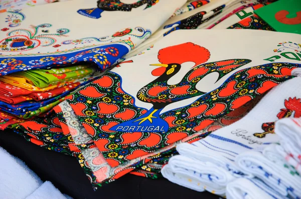 Souvenir towels with embroidery of the Galo de Barcelos (Barcelos Rooster) - traditional symbol of Portugal - at the street market in Porto (Portugal). — Stock Photo, Image