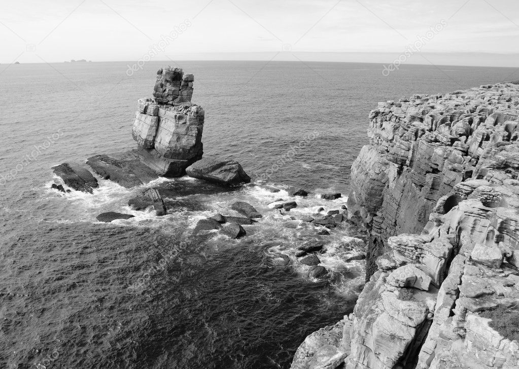 Beautiful rocks in water. Atlantic ocean coast near Peniche (Portugal). Black and white.