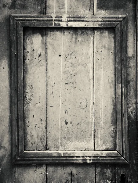 Weathered door with border frame. Aged photo. Black and white. — Stock Photo, Image