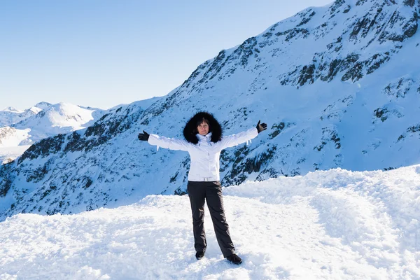 Middle-aged brunette on a background of mountains — Stock Photo, Image