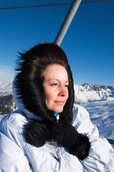 Middle-aged brunette on a background of mountains — Stock Photo, Image