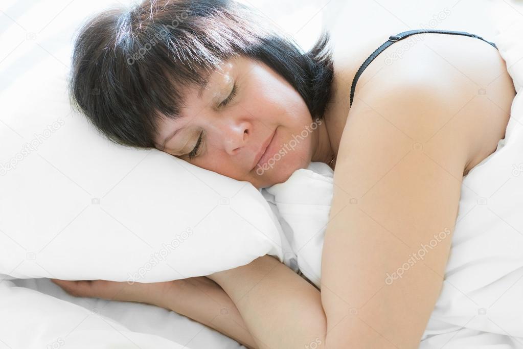 brunette woman in bed