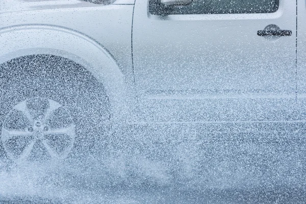 Car rain puddle splashing water — Stock Photo, Image