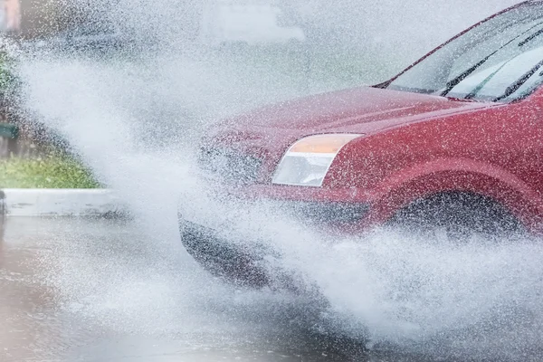 Car rain puddle splashing water — Stock Photo, Image