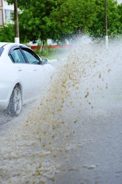 Car rain puddle splashing water — Stock Photo, Image