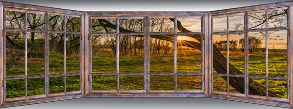 old wooden panoramic window overlooking a summer village landscape