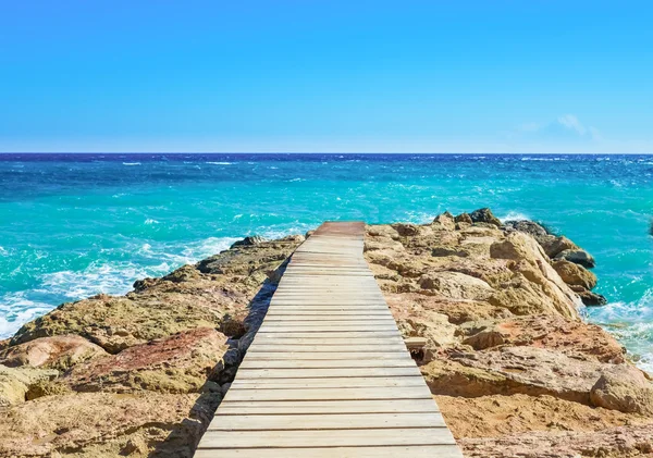 Wooden bridge juts out into  of the sea — Stock Photo, Image