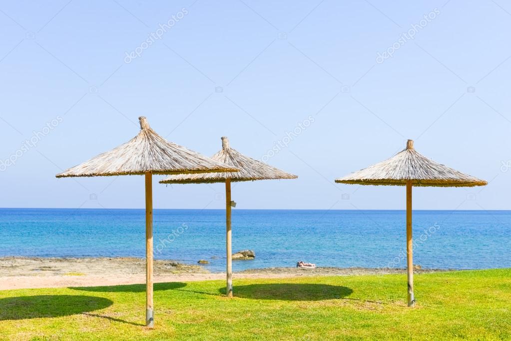 Parasol of straw on the sea — Stock Photo © dbrus 59467879