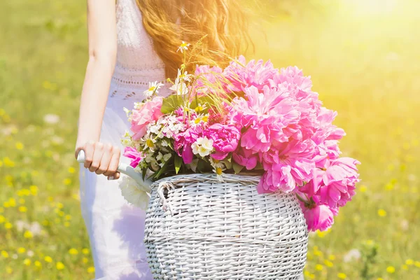 Panier blanc plein de fleurs et de pivoines sur le vélo de la mariée — Photo