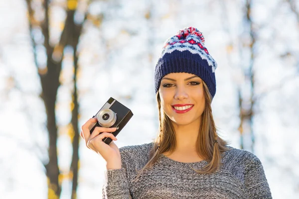 Young female photographer in autumn in park — Stock Photo, Image