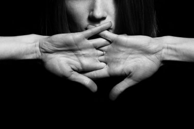 Closeup portrait of young woman hiding mouth by hands clipart