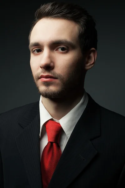 Portrait of a young handsome man (businessman) in black suit — Stock Photo, Image