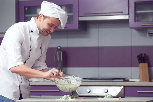 Vegetarian bakery concept. Chef cook putting filler made of spinach — Stock Photo, Image