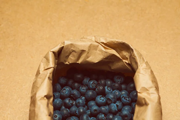 Raw food concept. Box with fresh blueberries packed in ecological material