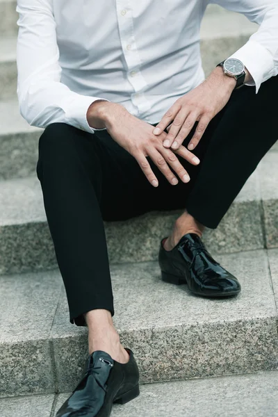 Luxurious and stylish concept. Rich young man sitting on marble — Stock Photo, Image