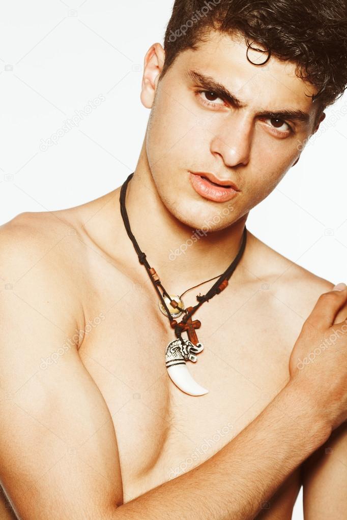 Emotive close up portrait of handsome young man with short curly