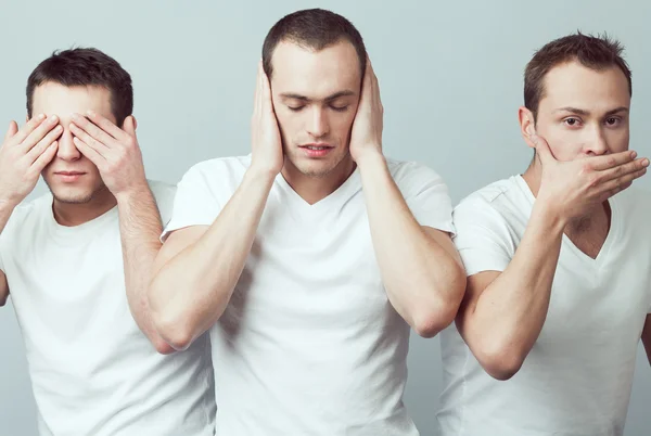 Closeup portrait of three young men in white t-shirts imitating — Stock Photo, Image