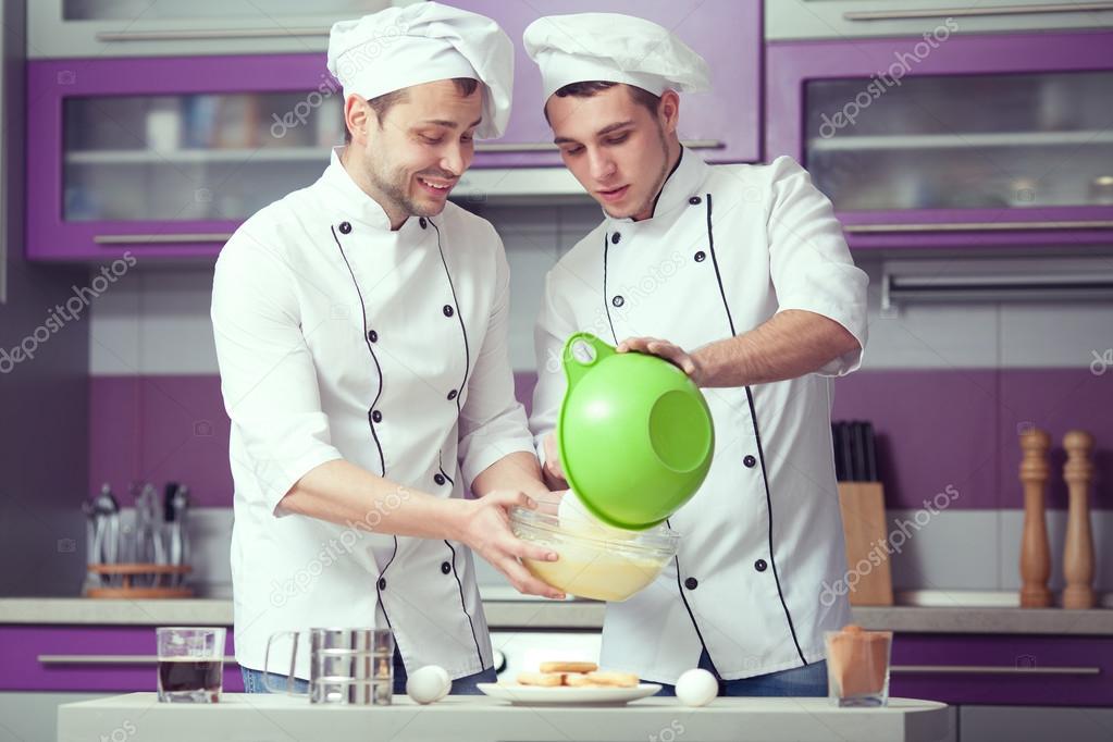 Tiramisu cooking concept. Portrait of two funny men in cook unif