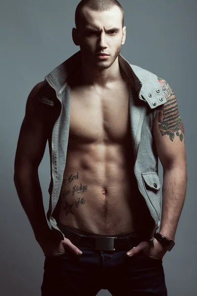 Portrait of tattooed brutal young man with short hair and bristl — Stock Image Portrait of tattooed brutal young man with short hair and bristl Royalty Free Stock Photos