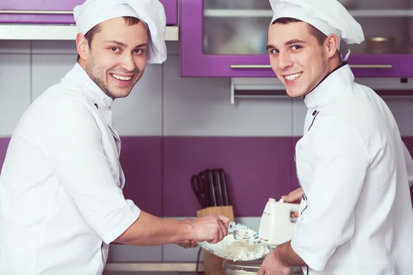 Dessert cooking concept. Portrait of smiling male chefs cooking — Stock Photo, Image