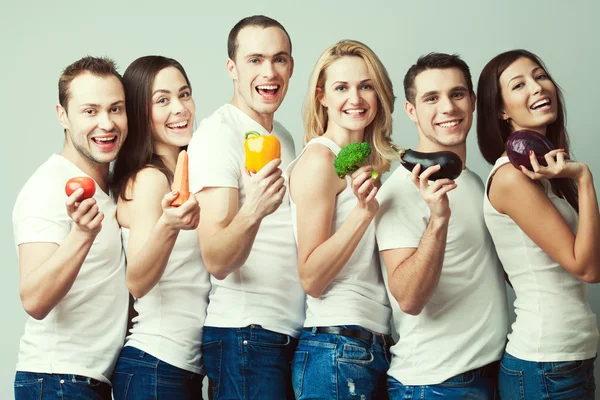 Feliz conceito de vegetais. Retrato em grupo de meninos e meninas saudáveis Imagens De Bancos De Imagens