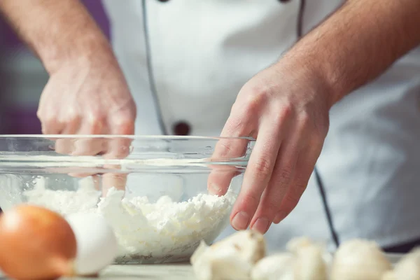 Vegetarian bakery concept. Chef's hands mixing feta cheese and e — Stock Photo, Image