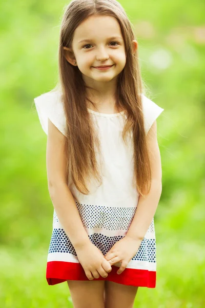 Stylish baby girl with long light brown hair in trendy vintage dress — Stock Photo, Image
