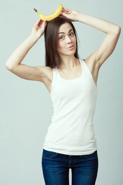 Raw, living food concept. Portrait of happy young woman with banana — ストック写真