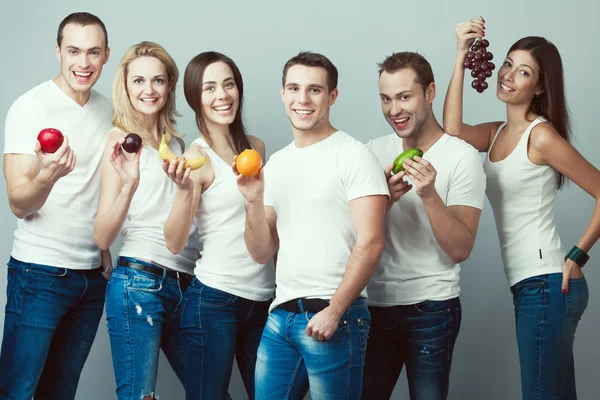 Raw, living food, veggie concept. Group portrait of healthy boys and girls Stok Fotoğraf