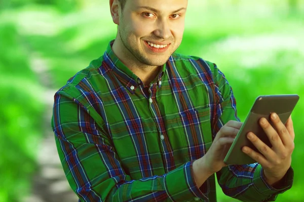Gadget user concept. Portrait of funny hipster guy using tablet