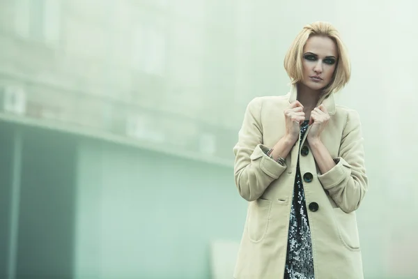 After party concept. Emotive portrait of beautiful blonde in coat — Stockfoto