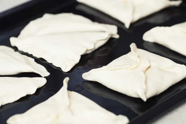 Vegetarian bakery concept. Wraps of puff pastry on baking sheet — Stock fotografie