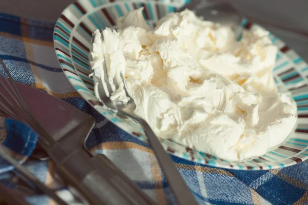 Tiramisu ingredient concept. Mixed mascarpone on plate