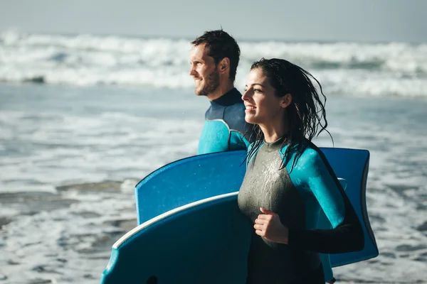 Happy healthy bodyboard surfing couple