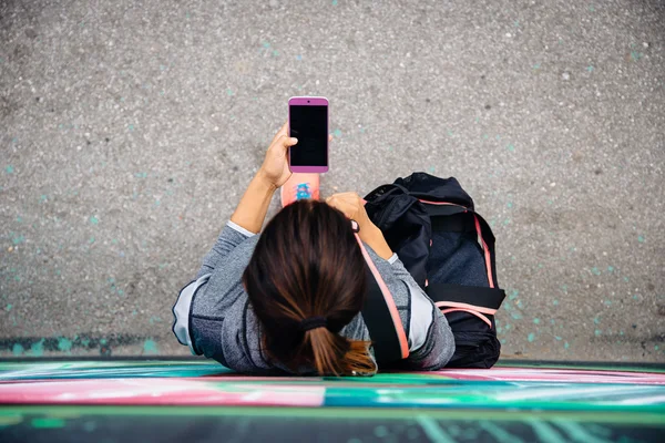 Městská sportovní žena textilie na smartphone — Stock fotografie