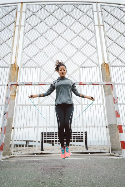 Fitness urban woman jumping rope