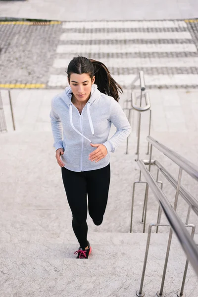 Sporty woman running and climbing stairs — Stock Photo, Image