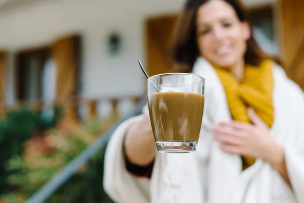 Woman offering cup of coffee on autumn — Stok fotoğraf