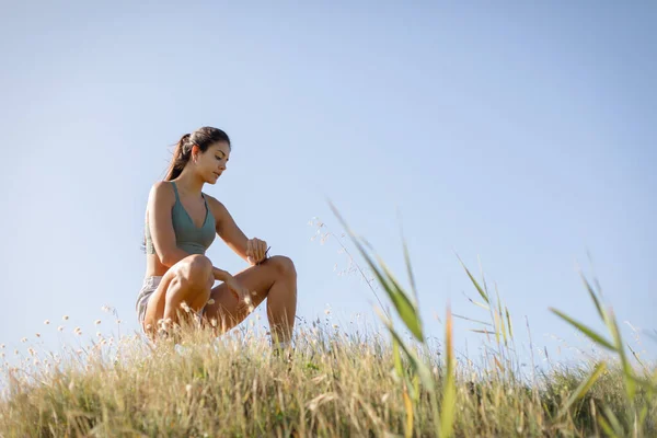 夏に自然の中でスポーティな若い女性のタイミング屋外ランニングやフィットネスワークアウトをフィット — ストック写真