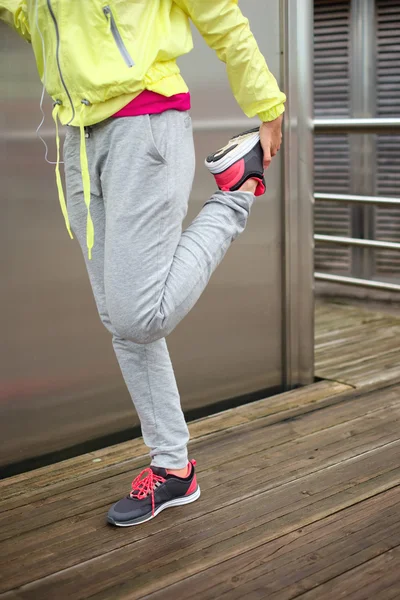 Female runner stretching leg before running — Stock Photo, Image